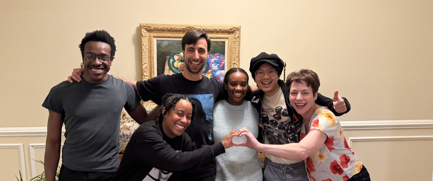 The crew of The Call, gathered together, several making a heart shape with their hands
