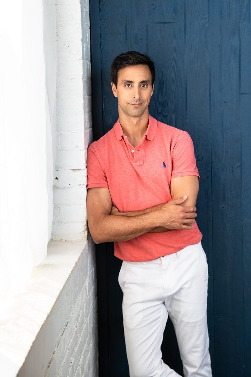 Tommy Hallal standing against a blue door